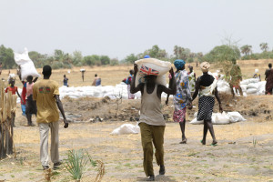 A man carries food aid parcel from UK near Leer, S. Sudan (Creative Commons)