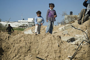 Children in Gaza rubble after 2016 invasion (image from wikimedia)