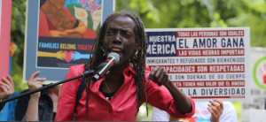 Joann Hardesty speaking into a microphone at a rally