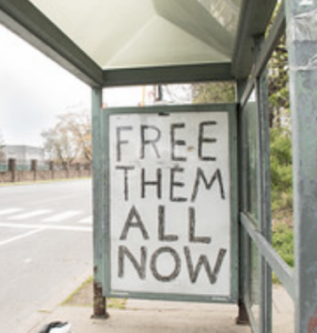 graffitti saying "Free Them All"