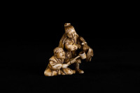 japanese_ivory_netsuke_of_two_men_with_a_hawk._signed_tomoyuki._mid_19th_century._photo_by_heather_hawksford.jpg